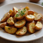 Delicious garlic roasted potatoes garnished with herbs, perfect for family meals.
